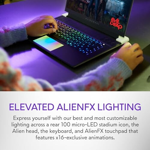 Person using a laptop with colorful AlienFX lighting.